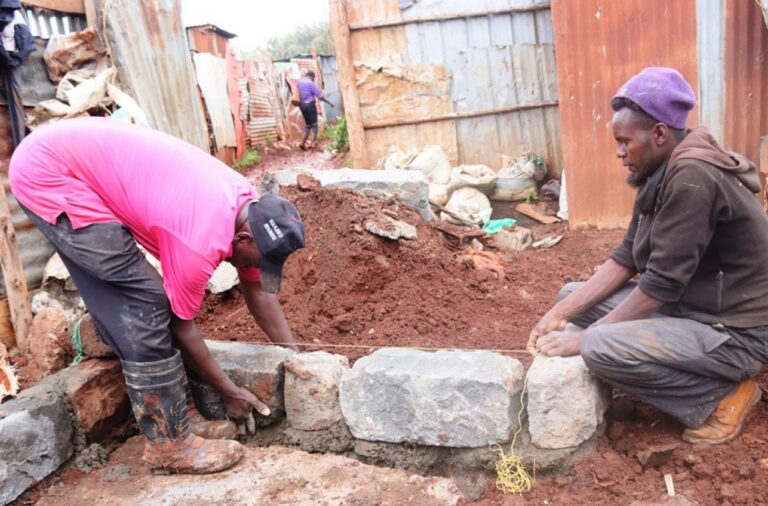 Community volunteers helping lay the foundation for Veronica's new home