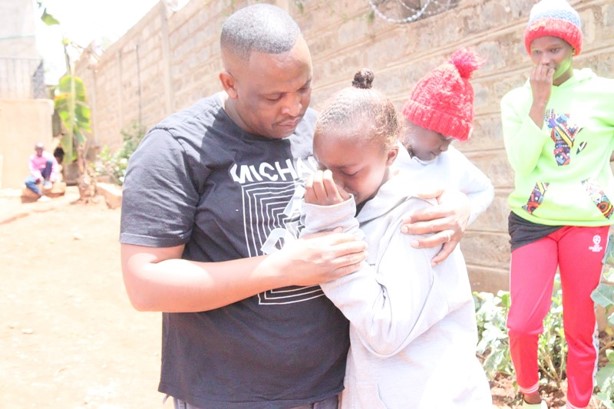 A moment of care between a volunteer and a teenager.