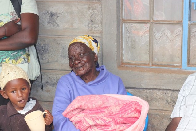 A grandmother cares for her grandchild with the foundation's help.