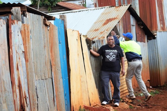 Inspecting timber and materials gathered for a community build.