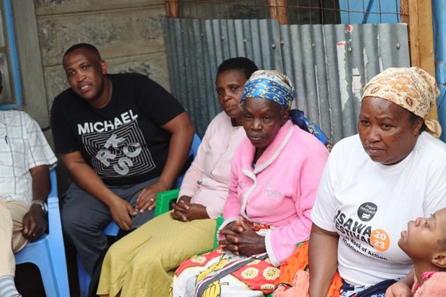 A small group meets to talk and pray together.