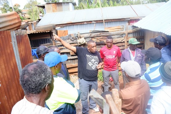 Neighbours come together to move materials and get to work.