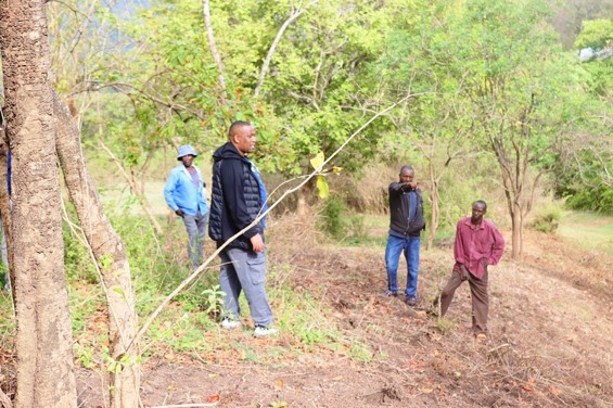 Assessing the open ground where the centre could stand.